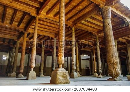 Ancient columns decorated with carved patterns in hall of Juma Mosque, Khiva, Uzbekistan. Special feature is that columns are collected from various ancient mosques, up to 10th century Royalty-Free Stock Photo #2087034403