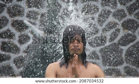 Man taking a shower with outdoor shower. ritual by bathing in holy water. Man relaxing in massage pool. frolicking in the shower.
