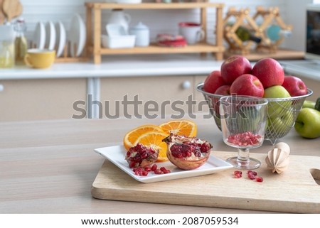 Healthy living and Vegan food. The fruits on the kitchen table were pomegranates, lemons, oranges, and apples.