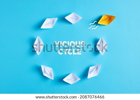 Breaking the vicious cycle in business or in daily life concept. One paper boat breaks the routine. Royalty-Free Stock Photo #2087076466
