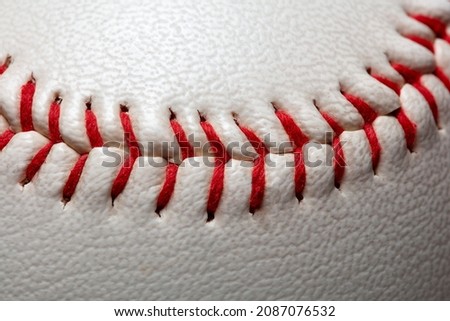 Macro close-up baseball ball with stiches and seam with copy space.