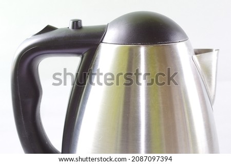 Metal electric kettle with white background.