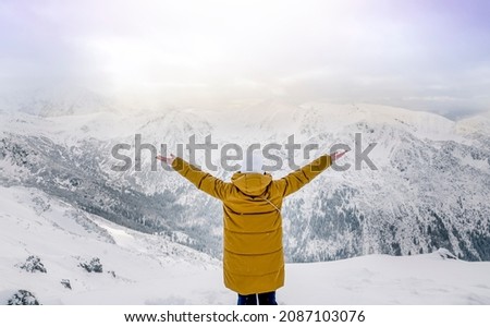 happy woman at the top of Kasprovy wierch during winter, Zakopane, Tatry mountains, Poland. High quality photo