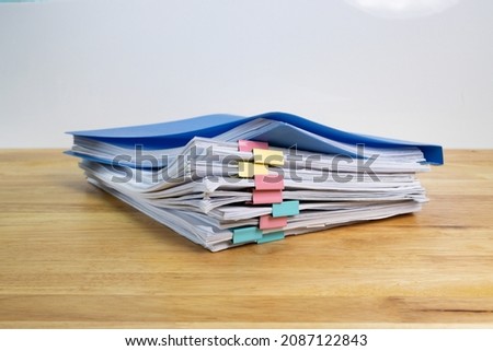 blue files folder and paper for business on wood table 