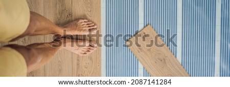 BANNER, LONG FORMAT Wooden floor, laminate on a warm film floor. Comfort in home. Warm floor concept. Heating in the house and apartment