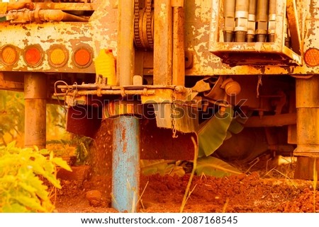 Working drill the artesian on blurred background, machine industry for dig dirt to hole of water underground for dry or irrigation rural or countryside  Royalty-Free Stock Photo #2087168545
