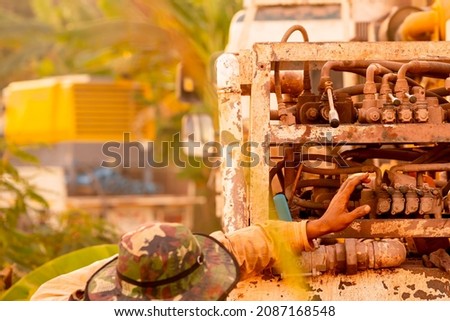 Working drill the artesian on blurred background, machine industry for dig dirt to hole of water underground for dry or irrigation rural or countryside  Royalty-Free Stock Photo #2087168548