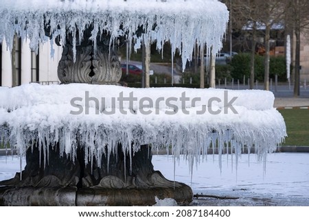 Close-up of the public fountain in Wiesbaden - Germany at the bowling green covered with many icicles 