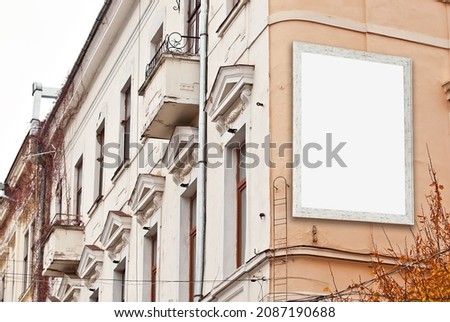 Rectangular sign on the building. Copy space and space for text. Mockup for design. Blank template for advertising. White frame on the facade of the house. Advertising on architecture.