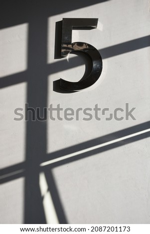The number five and the shadow of light