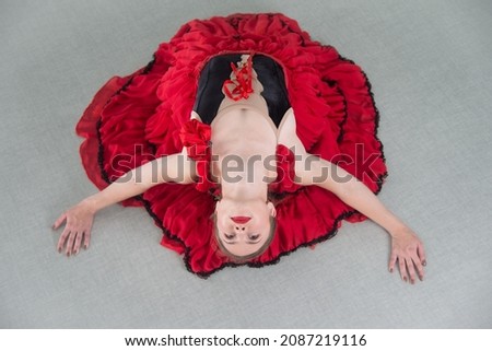 A ballerina in a black and red dress. The concept of dance art. 