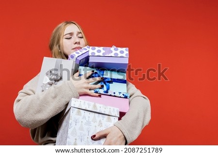 Birthday. Give gifts. Holiday. Celebrate. New year gifts. Christmas. Beautiful happy girl holding a lot of gift boxes in her hands.