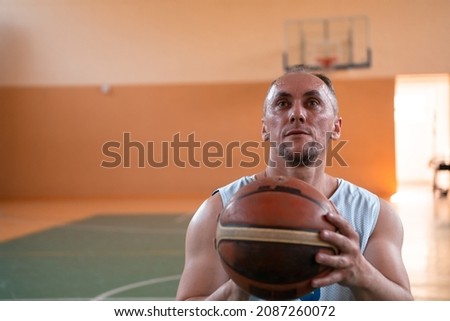 Close up photo of person with a disability playing basketball on the court. Selective focus 
