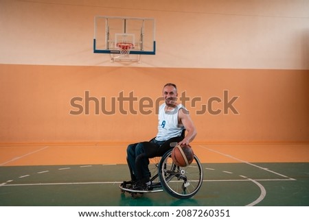 a photo of a person with a disability playing basketball in a modern sports arena. The concept of sport for person with a disability. Selective focus 