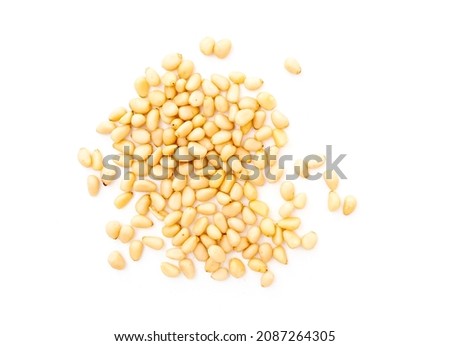 Heap of cedar or pine nuts isolated on white, top view Royalty-Free Stock Photo #2087264305