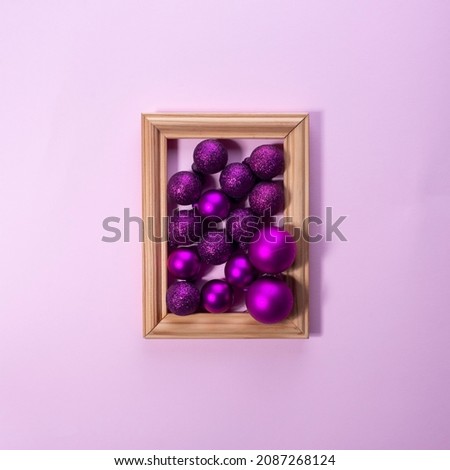 Christmas decorations in photo frame on pink background Christmas concept.