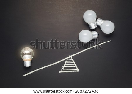 Only one light bulb that is glowing has more weight than many light bulbs that are not, less is more, success small idea, inspire and clarify concept Royalty-Free Stock Photo #2087272438
