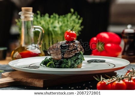 Medallions steaks from the beef tenderloin with spinach, Delicious balanced food concept,