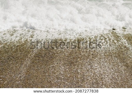 Sea foam on the sand in Sicily
