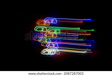 hallucinogenic light decoration of kitschy colors. replaces neons. long lines, loops, club flies through space. Christmas tree shape illuminated at night