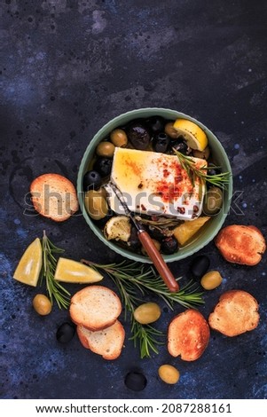 Baked Feta cheese Appetizer with Lemon, Olives and Rosemary.
