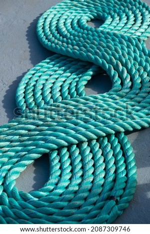 A green rope on a boat deck