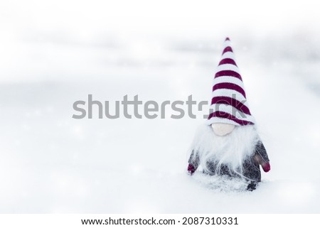 Merry christmas, little and cute dwarf with hat standing on the snow,useful for postcard, poster