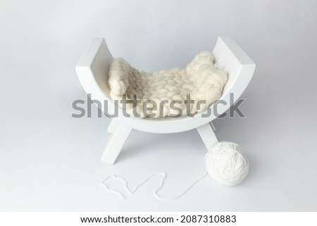 bed for children's photo shoots. background texture for photo of a newborn. wooden bed and a ball of thread for a kitten