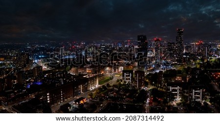 Aerial shot of Manchester, UK at night. Night skyscrapers standing in the city lights.