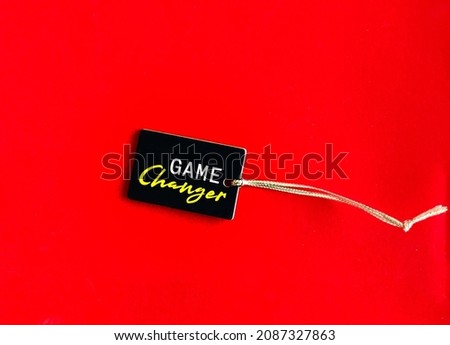 Price tag on red background with text written GAME CHANGER, concept of idea, event or element, factor that changes existing situation or activity significant way, player who suddenly changes game 