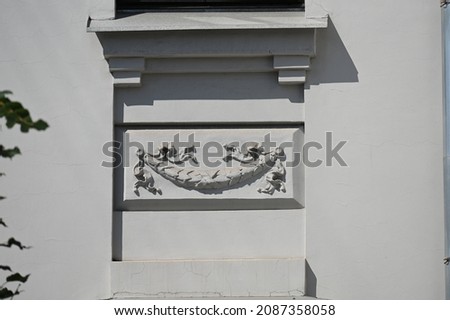 decor of a historic building in a shallow niche under a windowsill