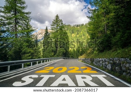 2022 New Year road trip travel and future vision concept . Nature landscape with highway road leading forward to happy new year celebration in the beginning of 2022 for fresh and successful start . Royalty-Free Stock Photo #2087366017