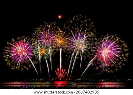 Abstract colorful firework display for celebration on dark background with free space for text. Colorful fireworks on the black sky background. New year holiday concept