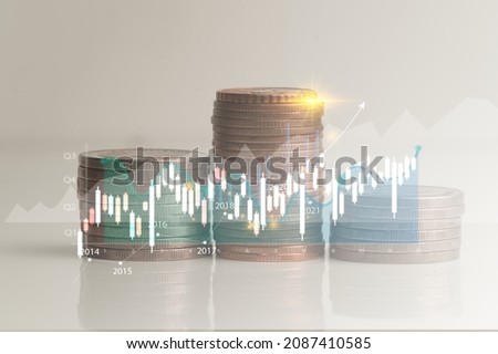 Stack of coins isolated from white background with graph lines reporting corporate earnings growth derived from valuation in economic investments. Royalty-Free Stock Photo #2087410585