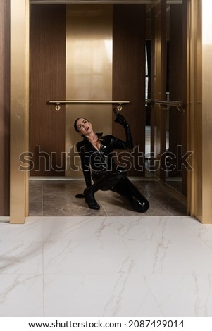 Hit woman. Woman in a latex suit killed in gunfire shot in the chest

 Royalty-Free Stock Photo #2087429014