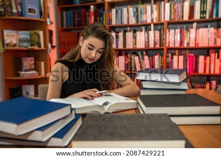 beautiful young girl after school studies in the city library. Library concept