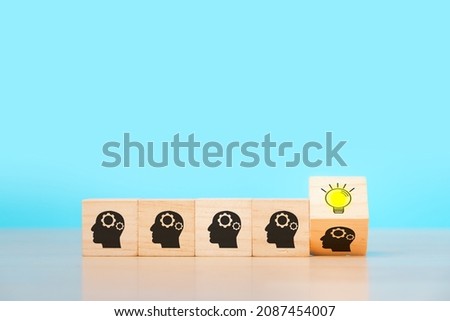wooden cube block with head human symbol and light bulb icon on blue background, copy space, Concept creative idea and innovation, idea, teamwork.