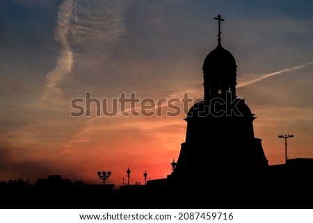 silhouette of the church on the background of the sunset sky in the summer. chapel in the city and beautiful sky