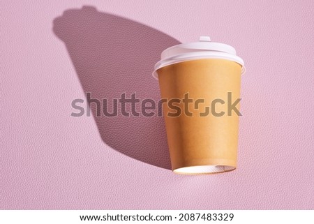 Paper disposable cup for hot coffee and tea on pink background.Concept and trend of takeaway food