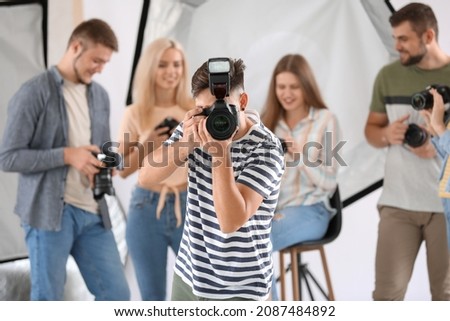 Male photographer taking picture in studio