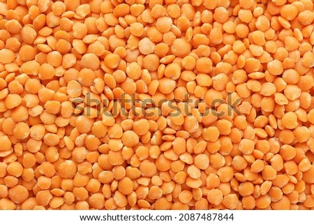 Heap of dry red lentils as background