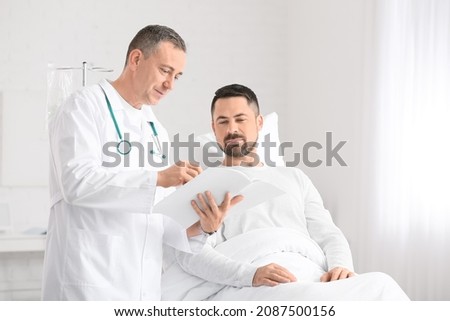 Doctor and man undergoing course of chemotherapy in clinic. Prostate cancer awareness concept Royalty-Free Stock Photo #2087500156