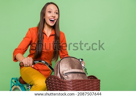 Profile side photo of mature excited lady ride transport look empty space isolated over green color background
