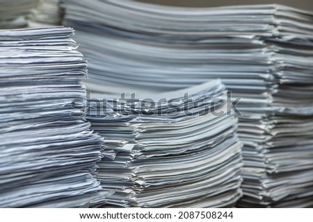 bundles bales of paper documents. stacks packs pile on the desk in the office. waste paper, paper trash Royalty-Free Stock Photo #2087508244