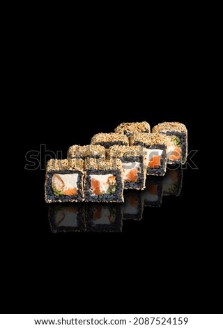 japanese rolls and sushi with fish and seafood on a black background