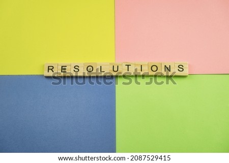 Word resolutions on a colorful background in pastel tones. Each color represents a New Years resolution.