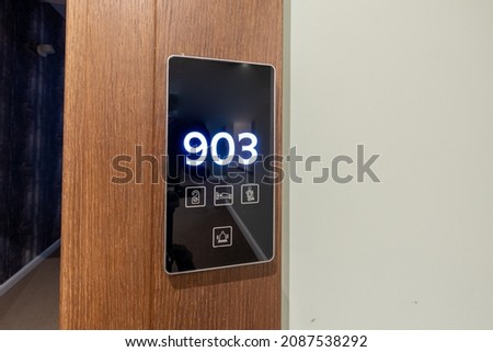 Hotel room number mounted on a wall