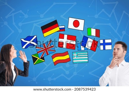 Attractive young european business woman and man talking to each other on blue background with abstract colorful flag drawings. Travel, translation and language learning concept