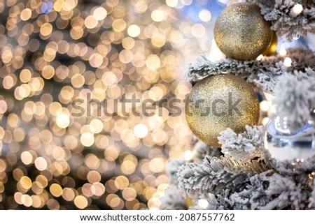 snow christmas tree decorated with silver and golden Christmas toys, christmas atmosphere,festive mood, decoration of shops before the new year and Christmas, new Year decorations, photo zone