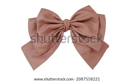 Bow hair with tails in beautiful soft brown color and white background, so elegant and fashionable. This hair bow is a hair clip accessory for girls and women. Royalty-Free Stock Photo #2087558221